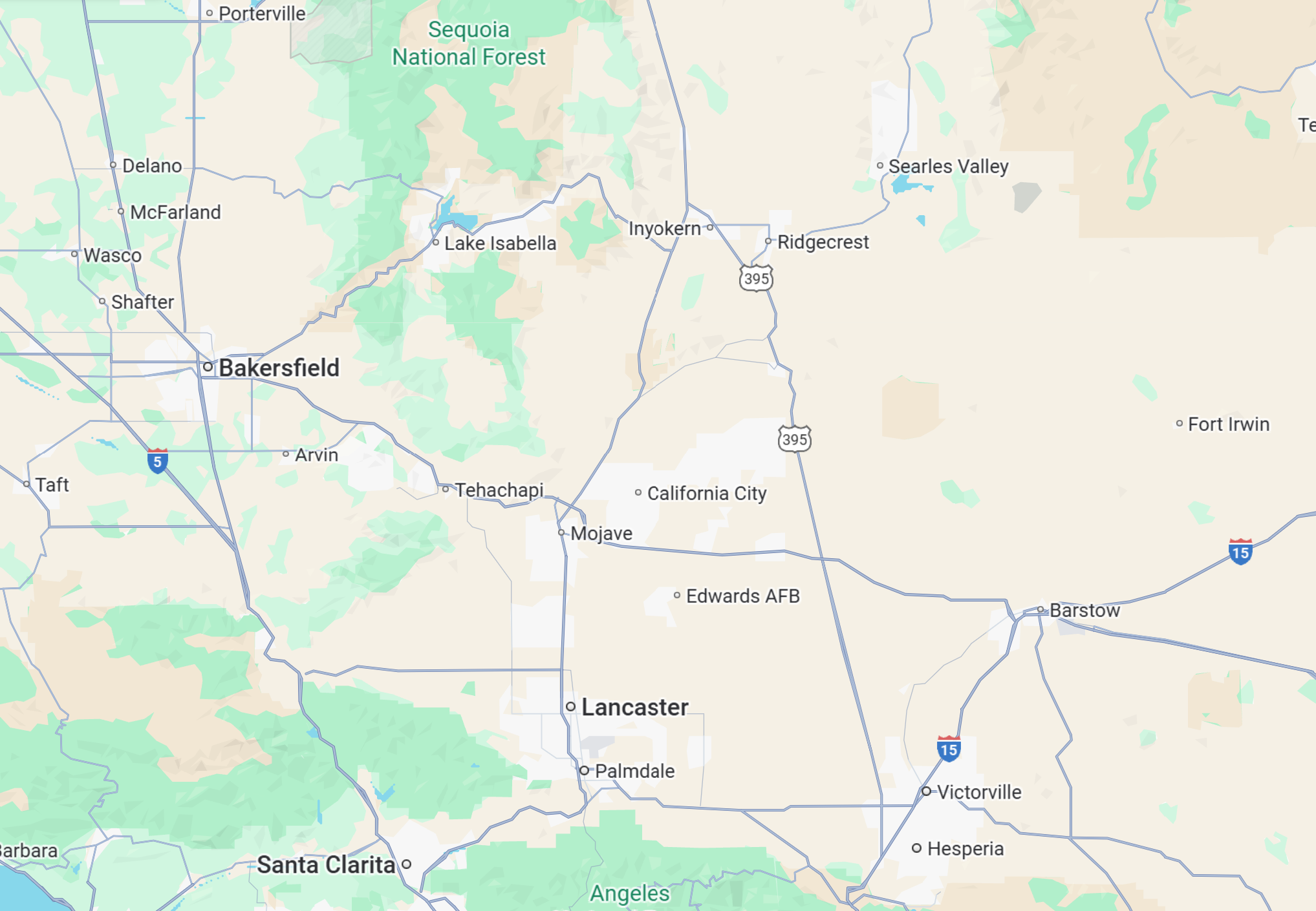 A technician in gloves uses an adjustable wrench to fix equipment on a wall, surrounded by pipes and valves.